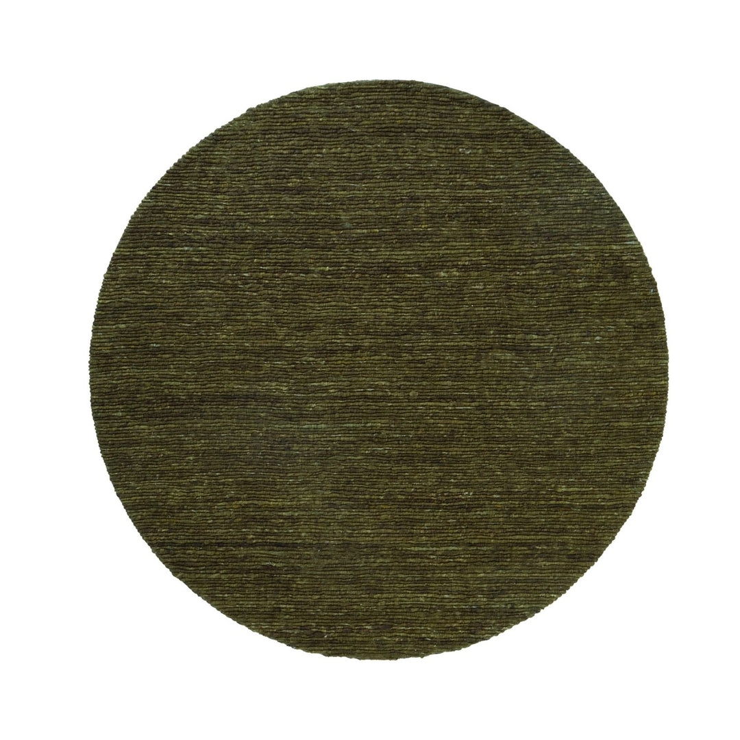Round green rug on a white background