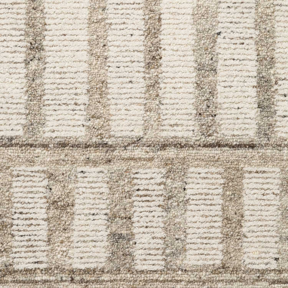 Close-up of a textured beige and brown carpet with geometric pattern