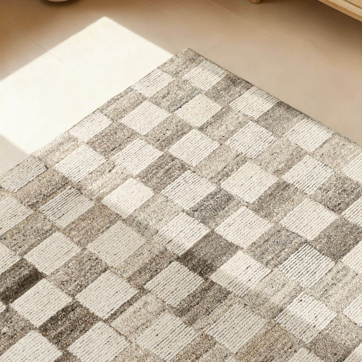 Checkered patterned rug on a wooden floor