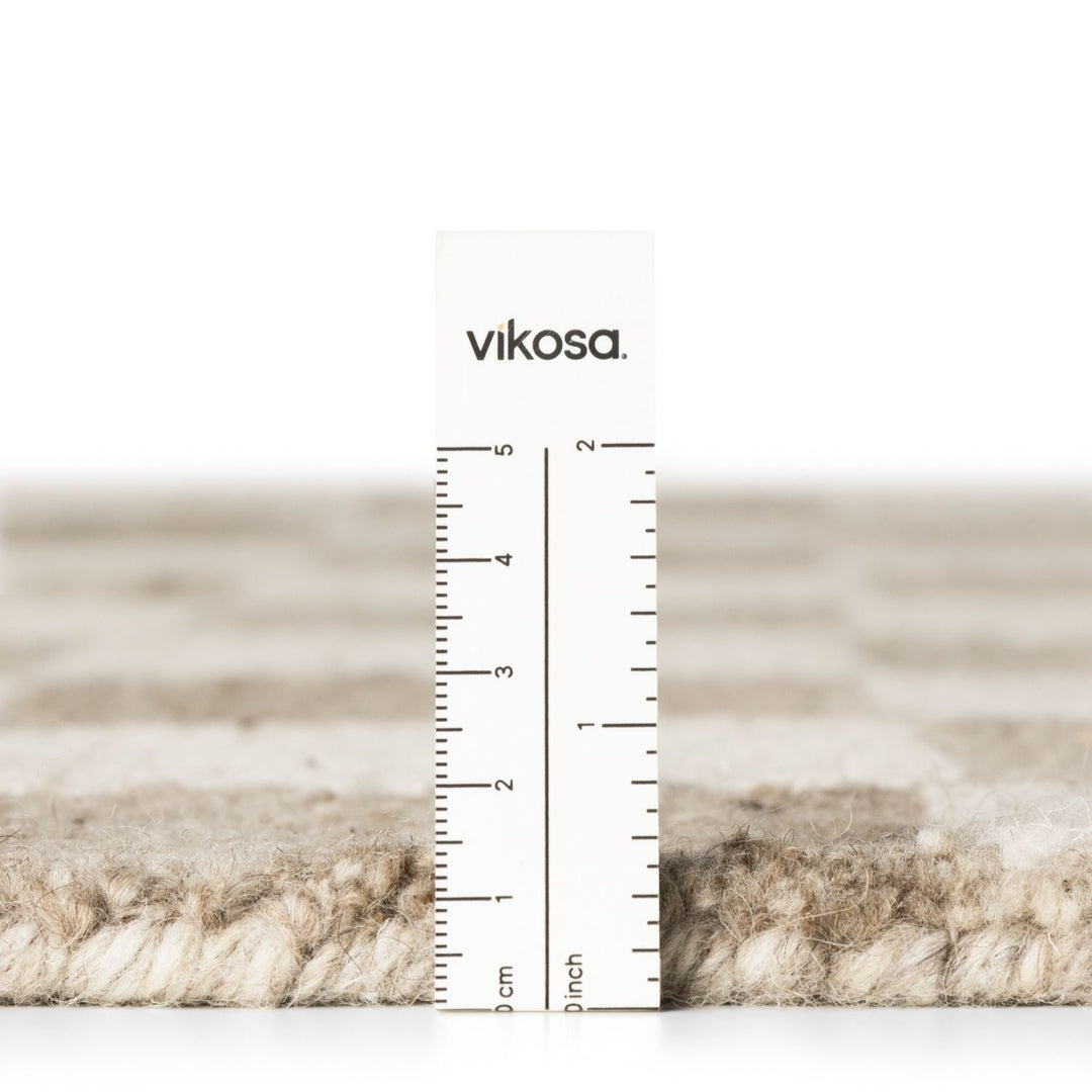 Textured material swatch with a ruler and 'vikosa' branding on a white background