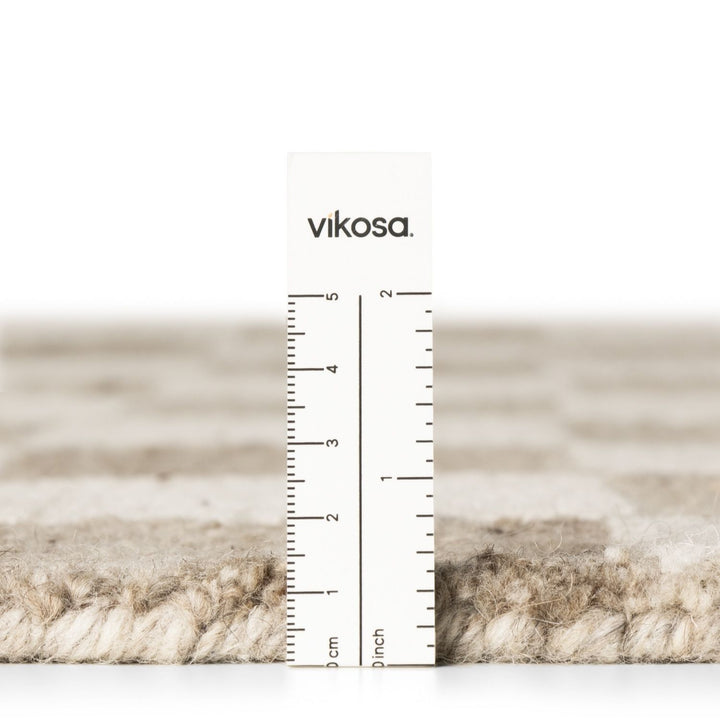 Textured material swatch with a ruler and 'vikosa' branding on a white background