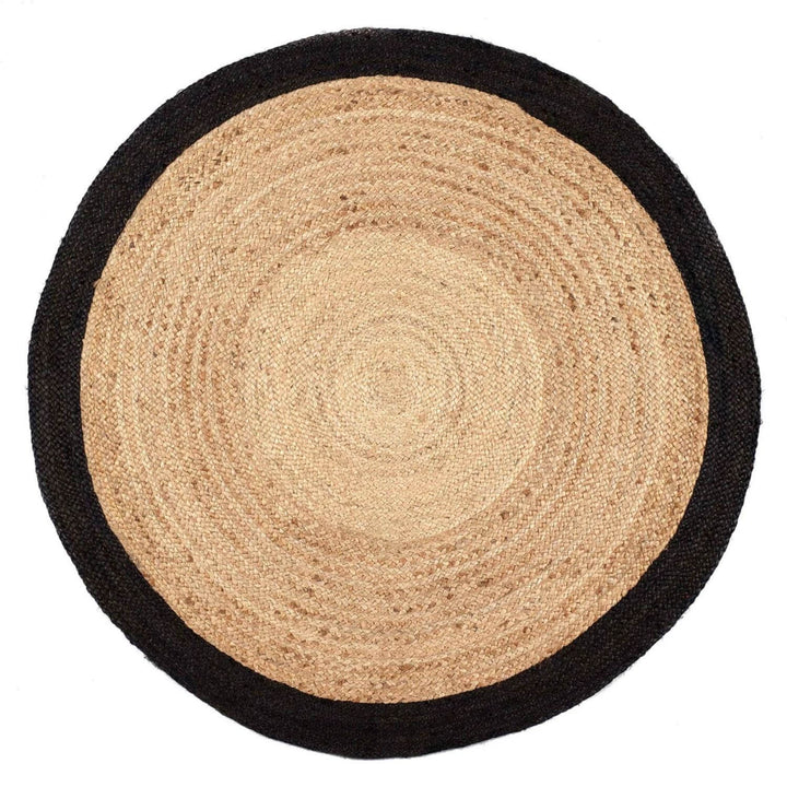 Round jute rug with black border on a white background