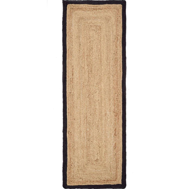 Beige jute rug with black border on a white background