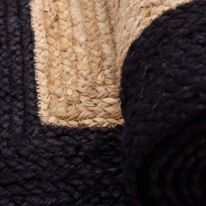 Close-up of textured black and beige rug corner
