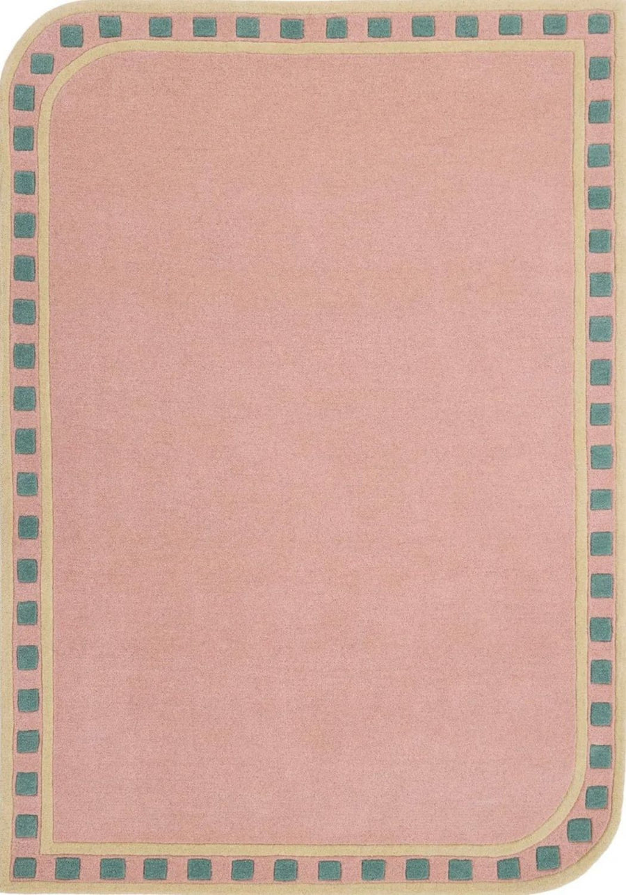 Pink rug with a border featuring small squares in green and beige.