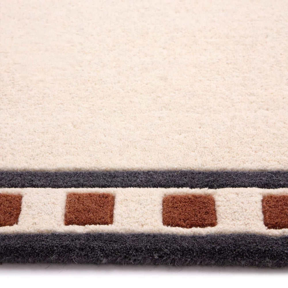 Close-up of a textured rug with geometric pattern on a white background