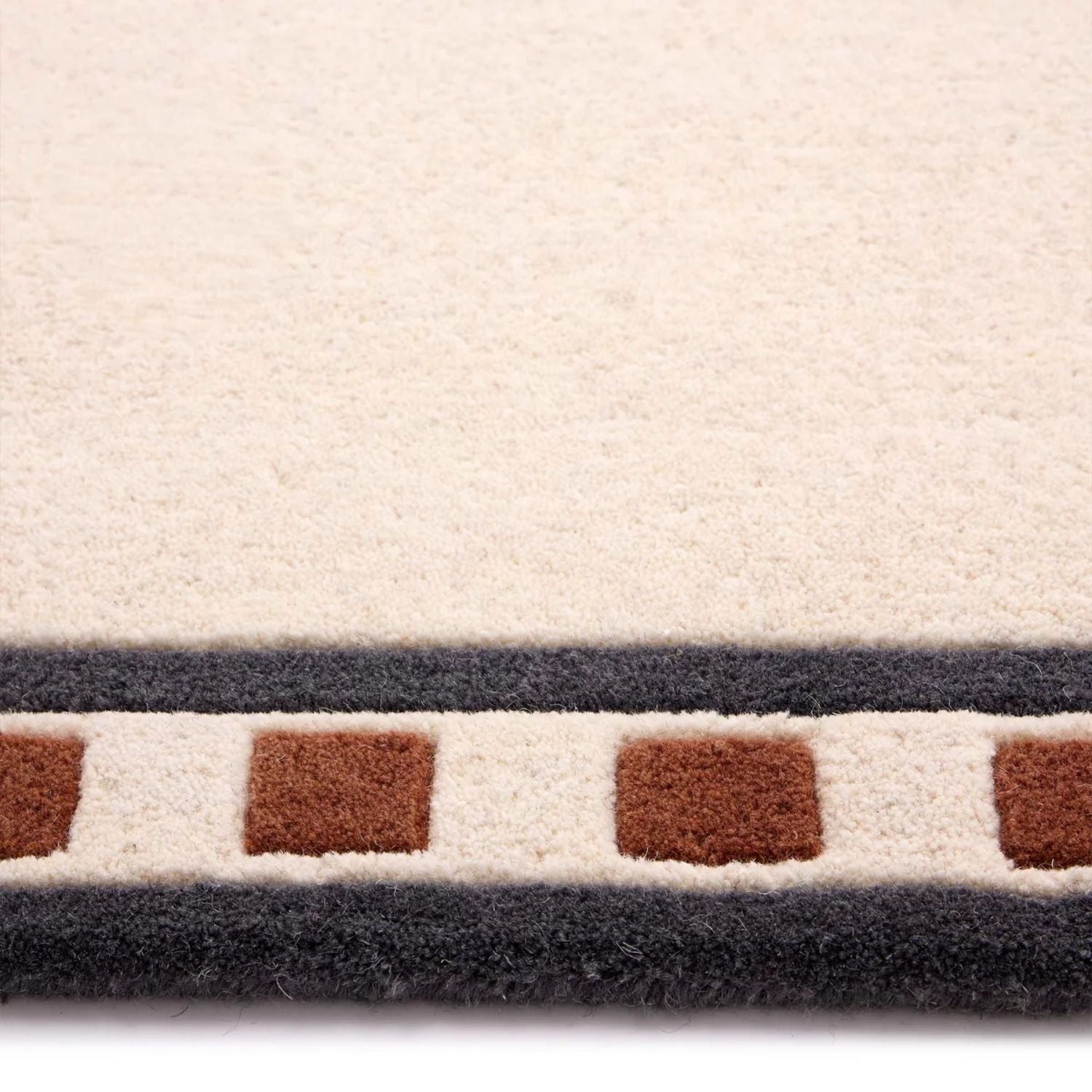 Close-up of a textured rug with geometric pattern on a white background