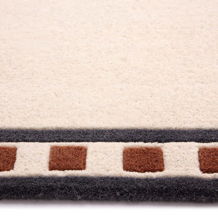 Close-up of a textured rug with geometric pattern on a white background