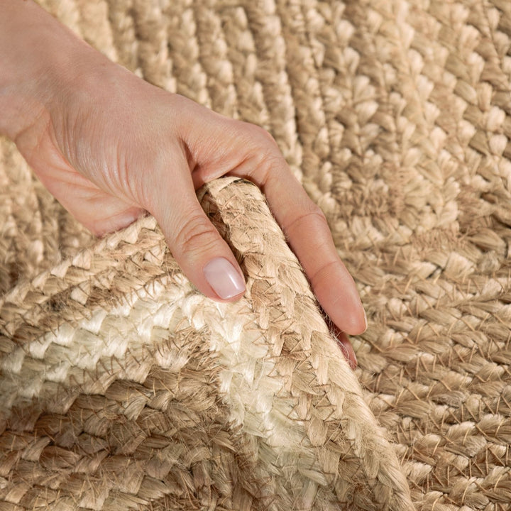 Hand touching a textured woven surface