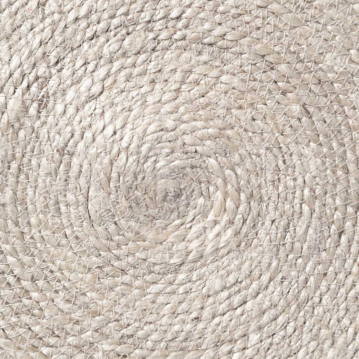 Close-up of a woven beige mat with a circular pattern