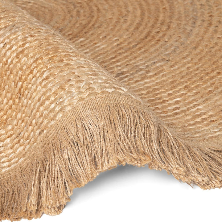 Close-up of a textured beige fabric with fringes on a white background