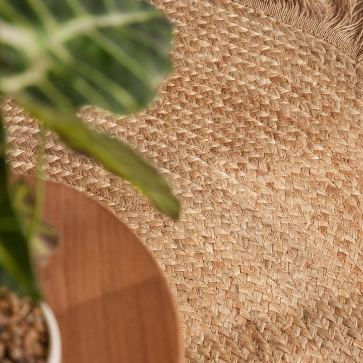 Close-up of a woven mat with a plant in the foreground