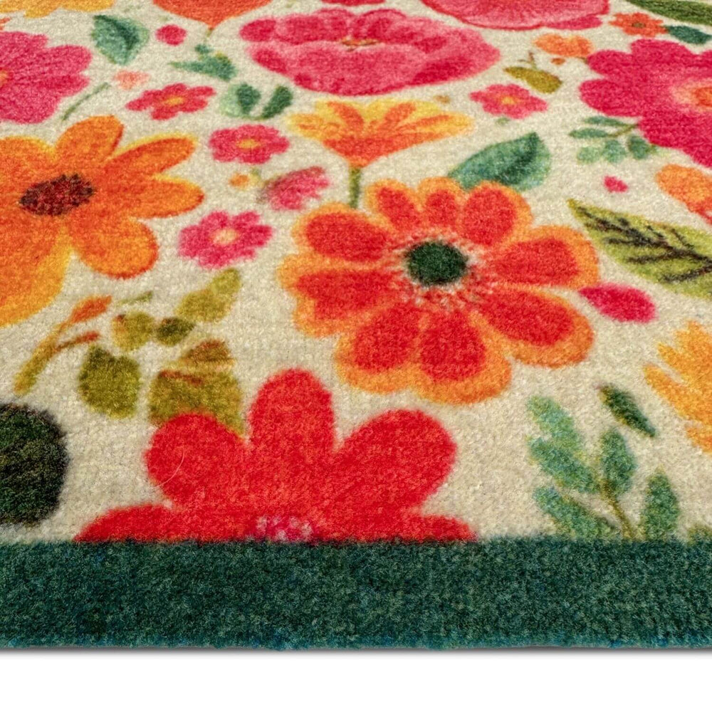 Close-up of a floral patterned rug with vibrant colors on a white background.