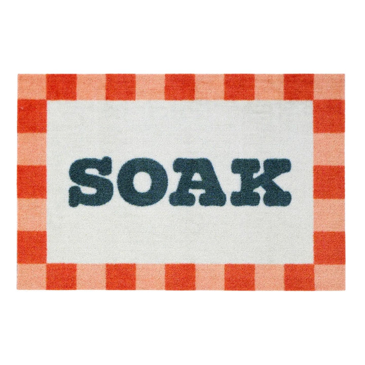 Doormat with red and white checkered border and 'SOAK' text in the center