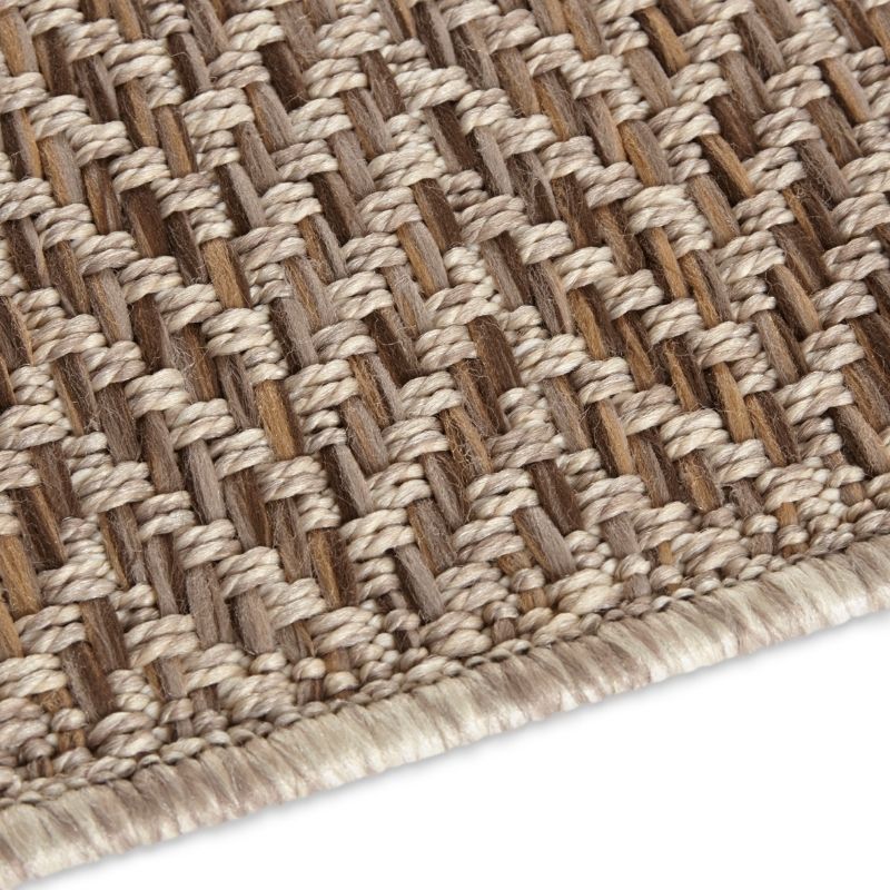 Close-up of a woven brown and beige rug on a white background