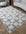 Checkered area rug on a wooden floor with a sofa and chair in the background
