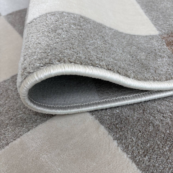 Gray geometric patterned rug with a textured border