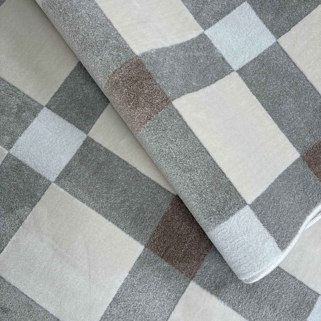 Checkered fabric with gray, white, and brown squares