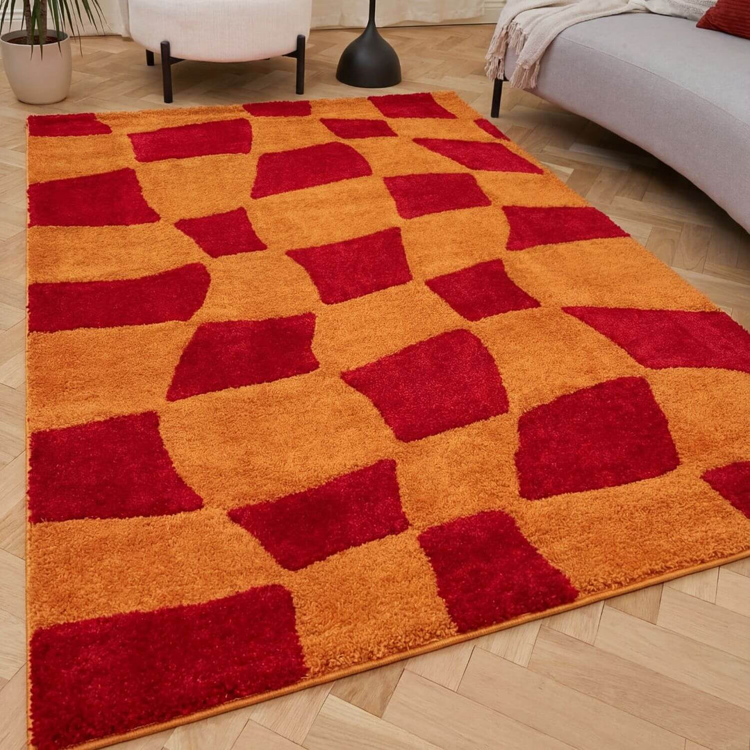 Red and orange checkered rug on a wooden floor