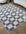 Checkered area rug on a wooden floor with a sofa and chair in the background