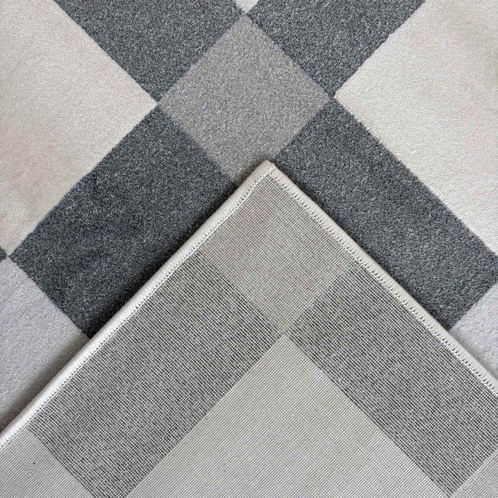 Gray and white checkered patterned rug