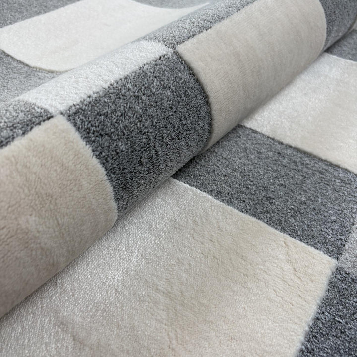 Close-up of a gray and white checkered patterned rug.