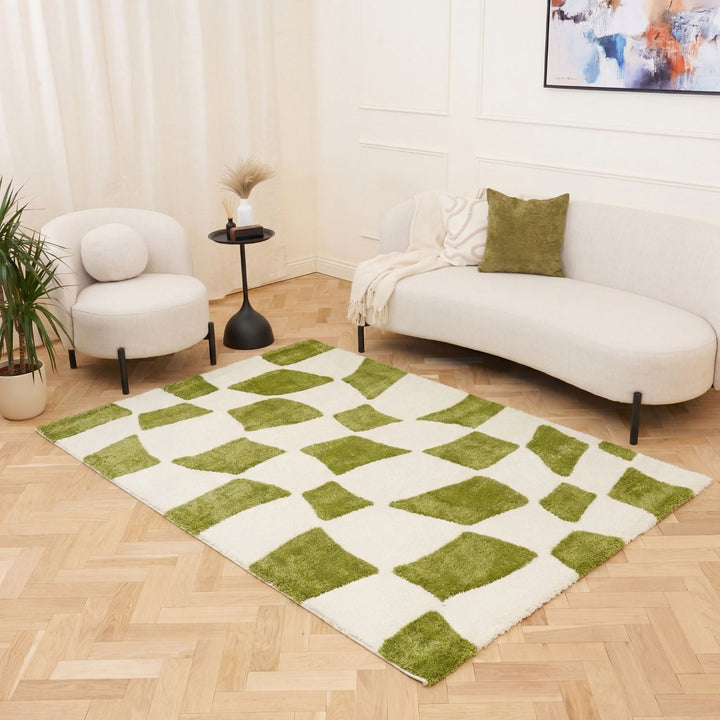Living room with a green and white checkered rug, white sofa, and armchair.