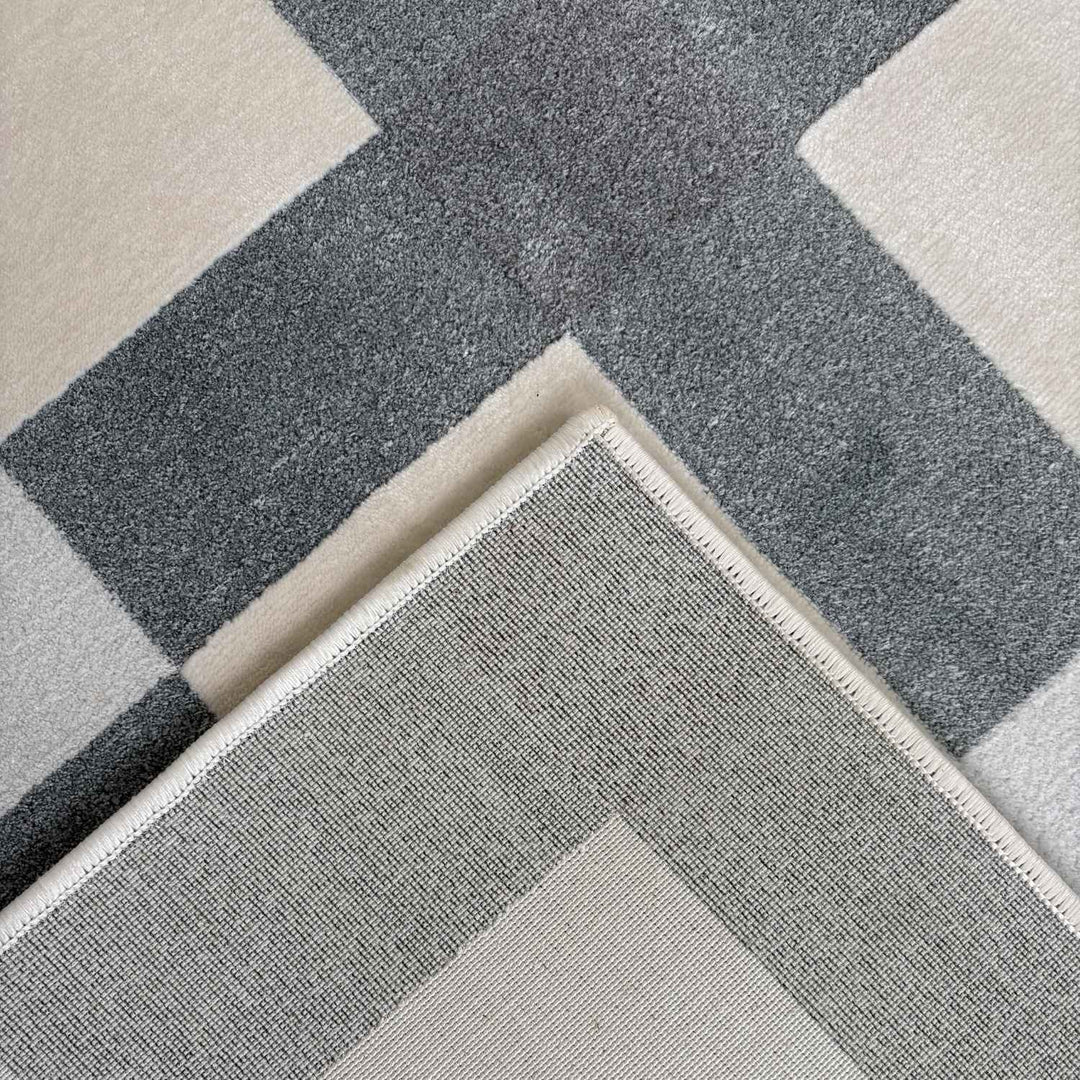 Gray and beige checkered patterned rug