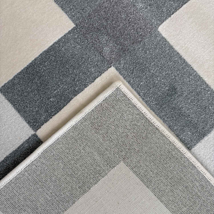 Gray and beige checkered patterned rug
