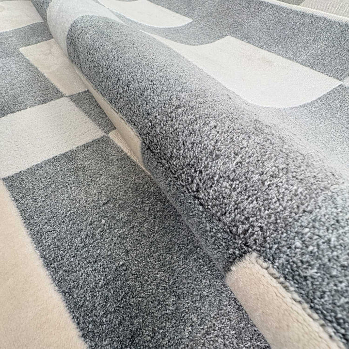 Gray and beige checkered patterned rug