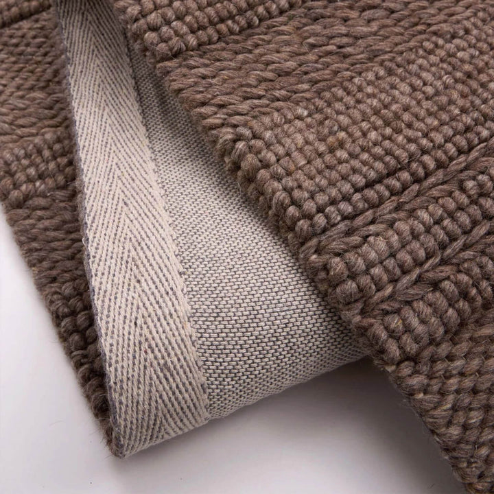 Close-up of brown textured fabric on a white background
