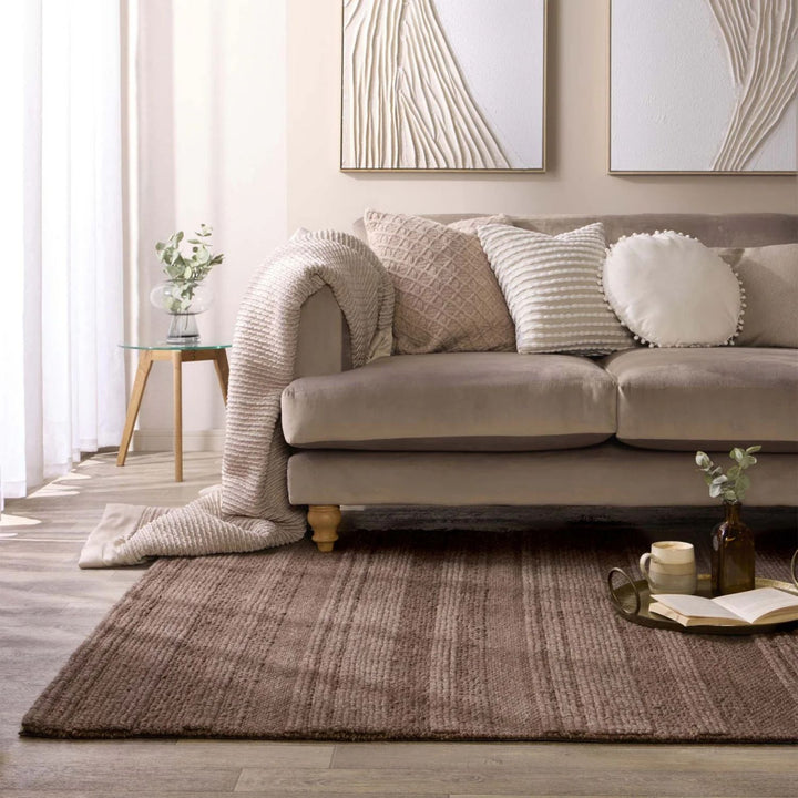 Beige sofa with decorative pillows in a living room setting