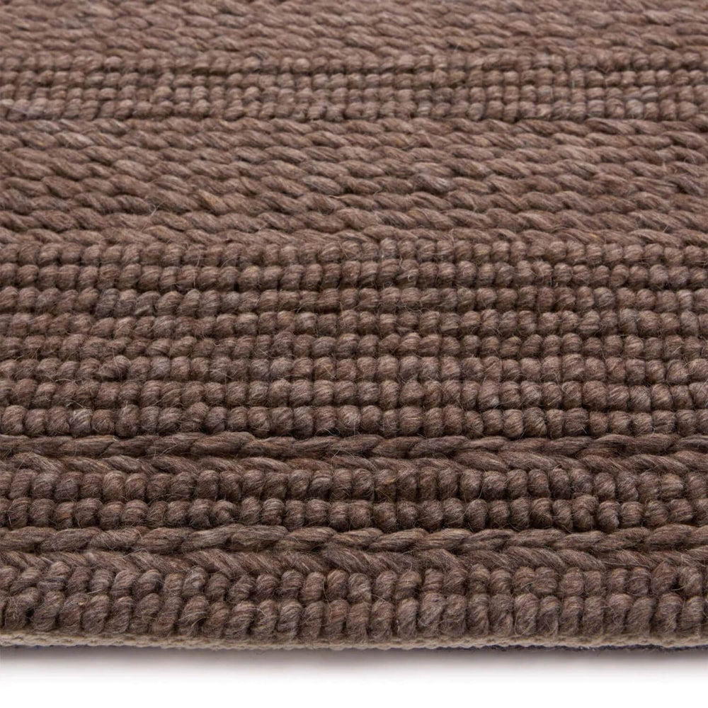 Close-up of a brown textured rug on a white background