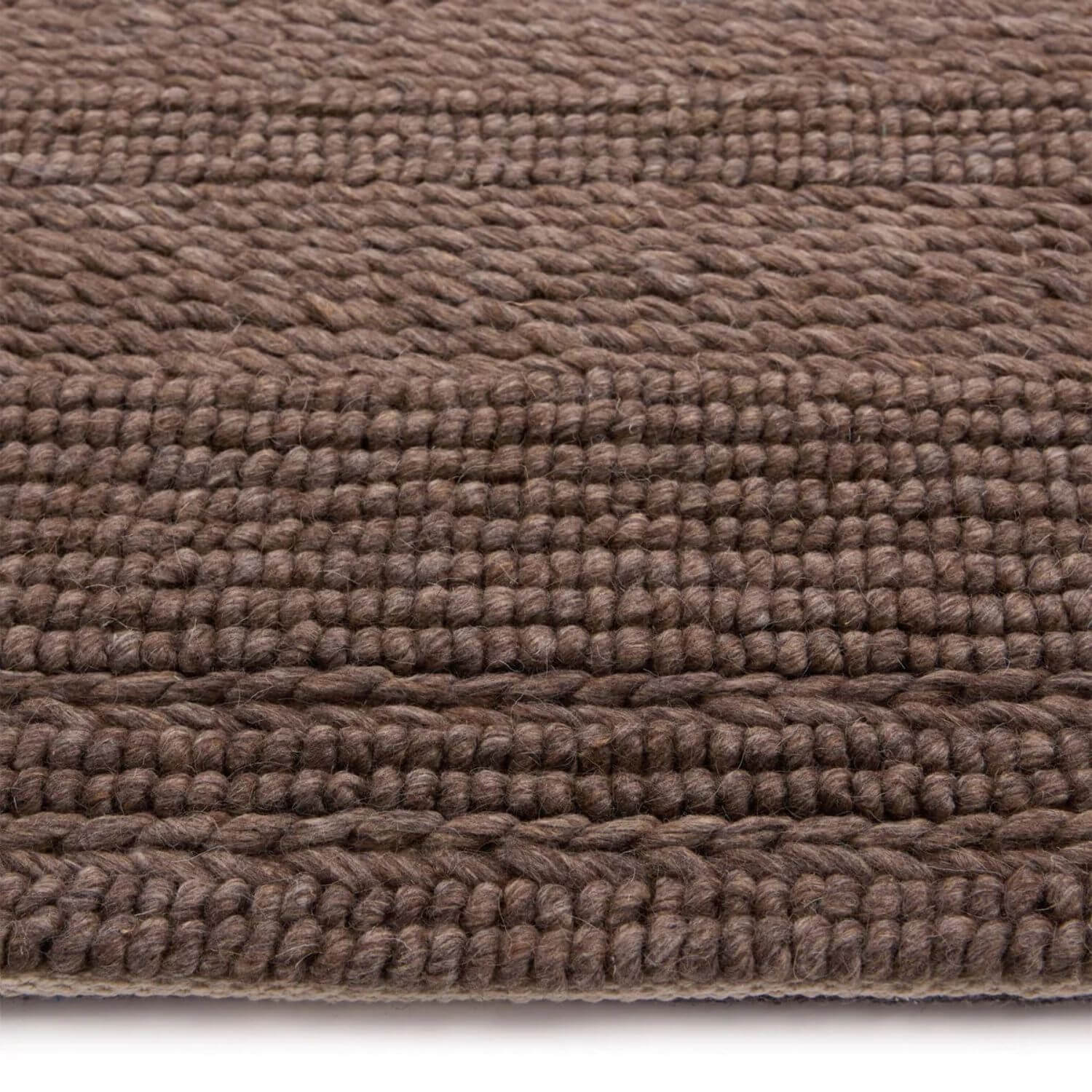 Close-up of a brown textured rug on a white background