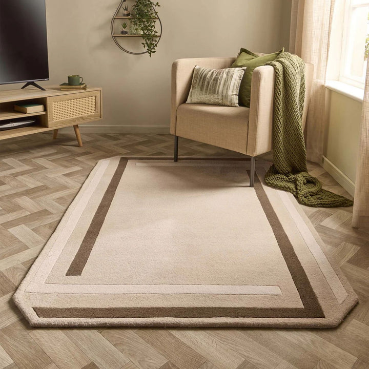 Living room with a beige rug, armchair, and television stand.