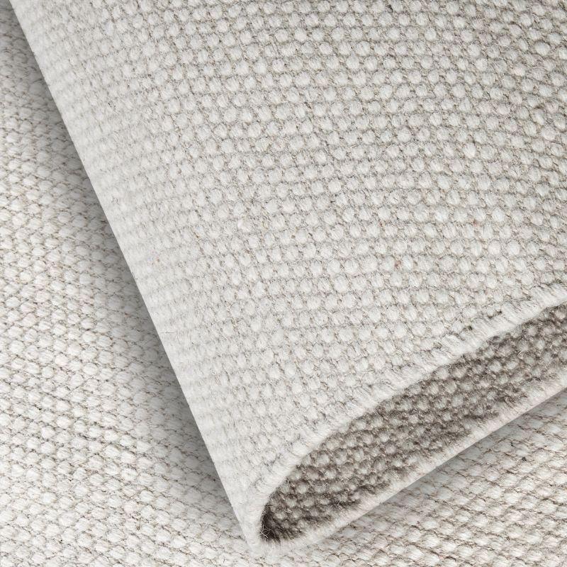 Close-up of textured gray fabric with a subtle pattern