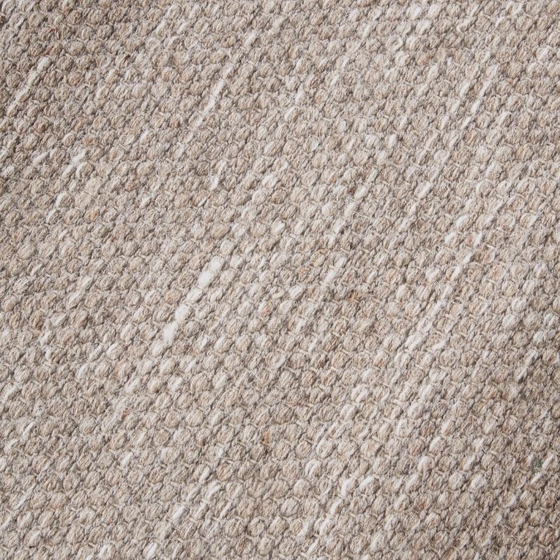Close-up of a textured beige carpet