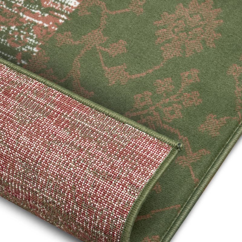 Close-up of a green and red patterned rug corner