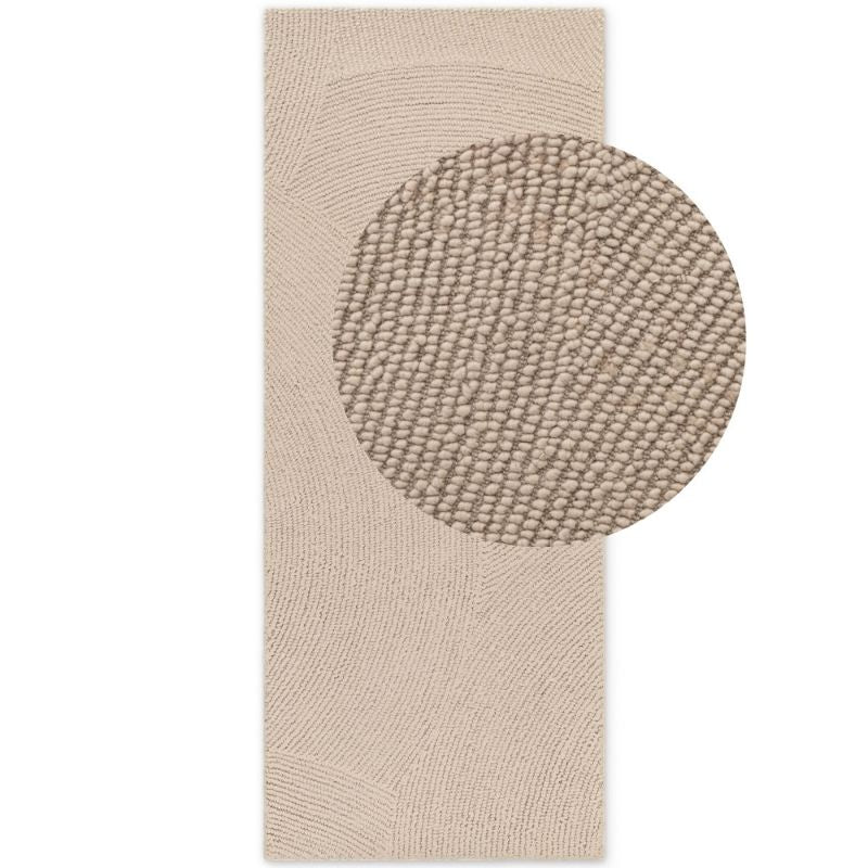 Beige textured rug with a circular pattern on a white background