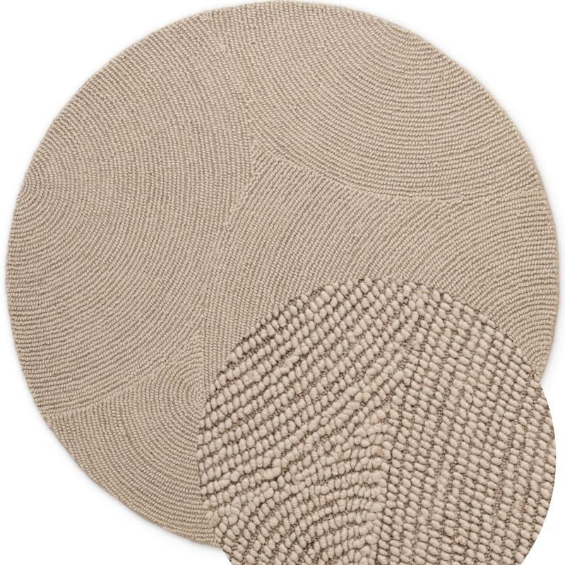 Round beige rug with textured pattern on a white background