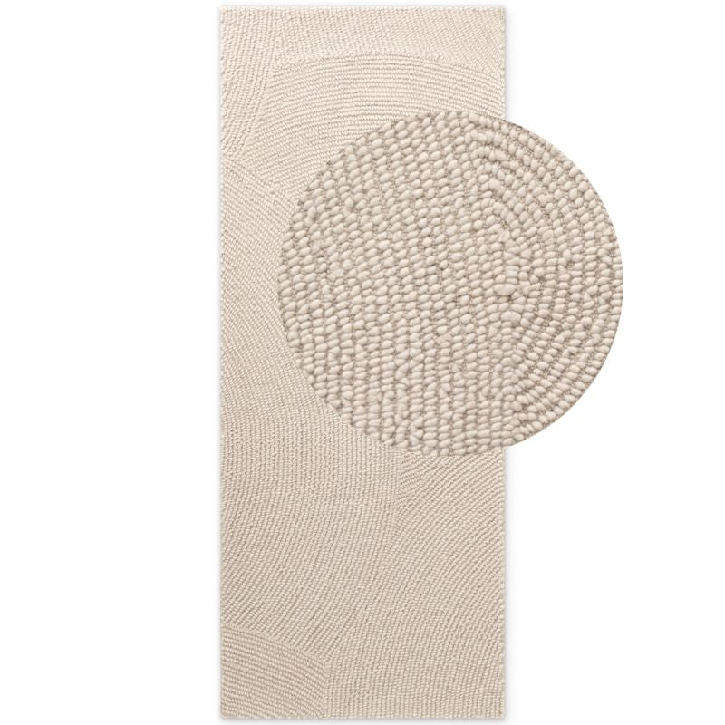 Beige textured bath mat with circular design on a white background