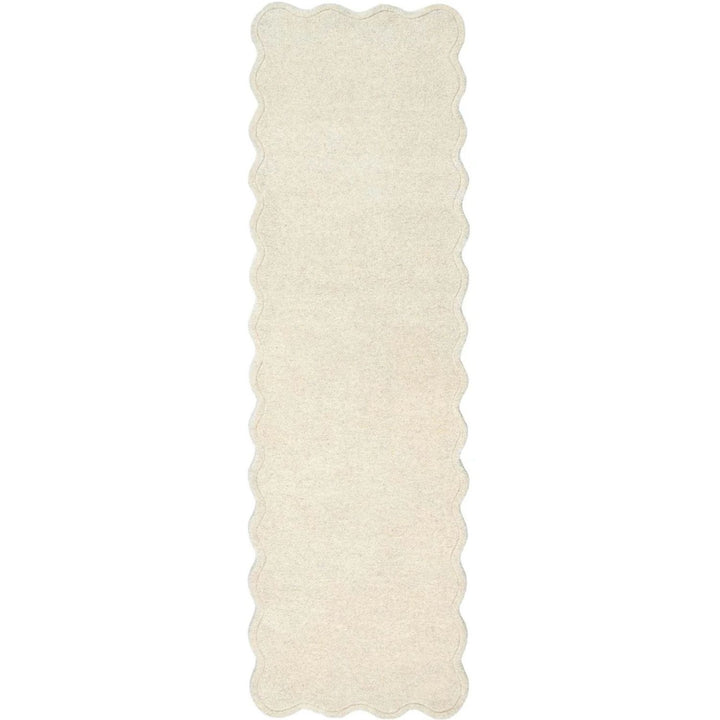 Rectangular white rug with scalloped edge on a white background
