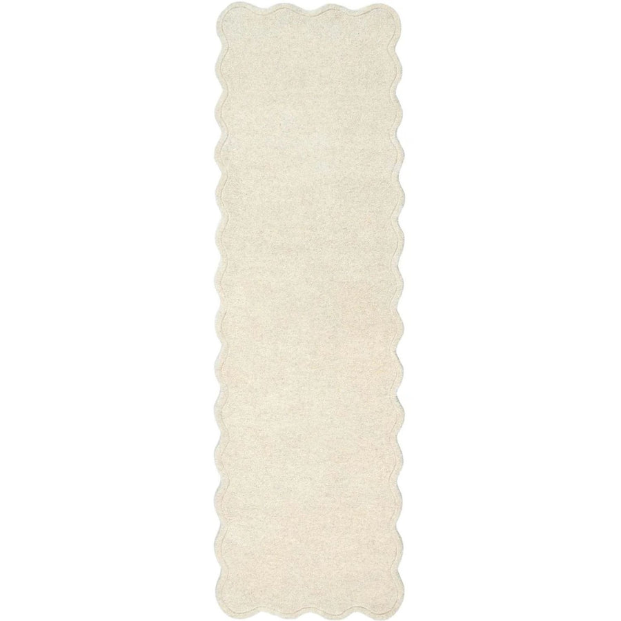Rectangular white rug with scalloped edge on a white background