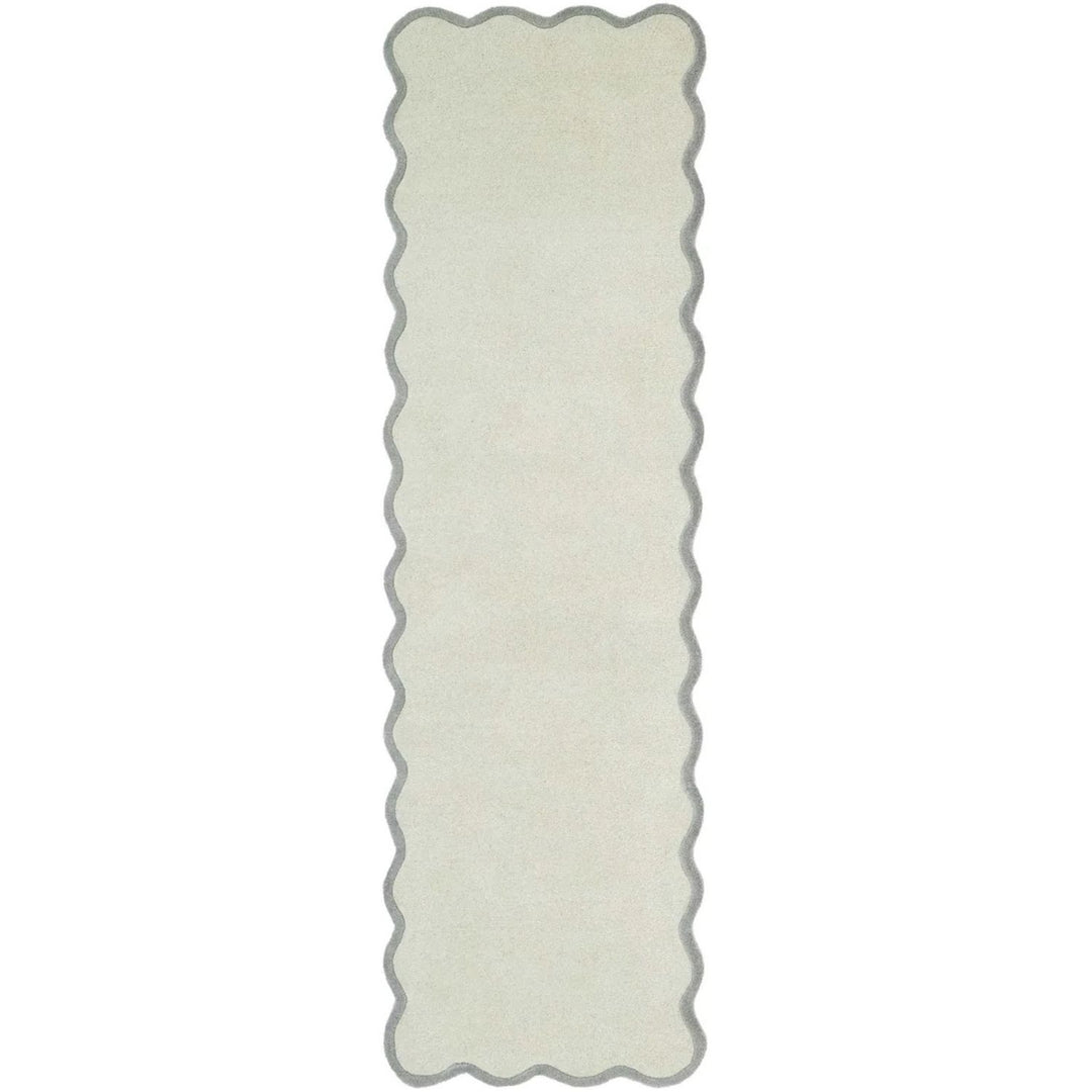 Rectangular white rug with scalloped edge on a white background