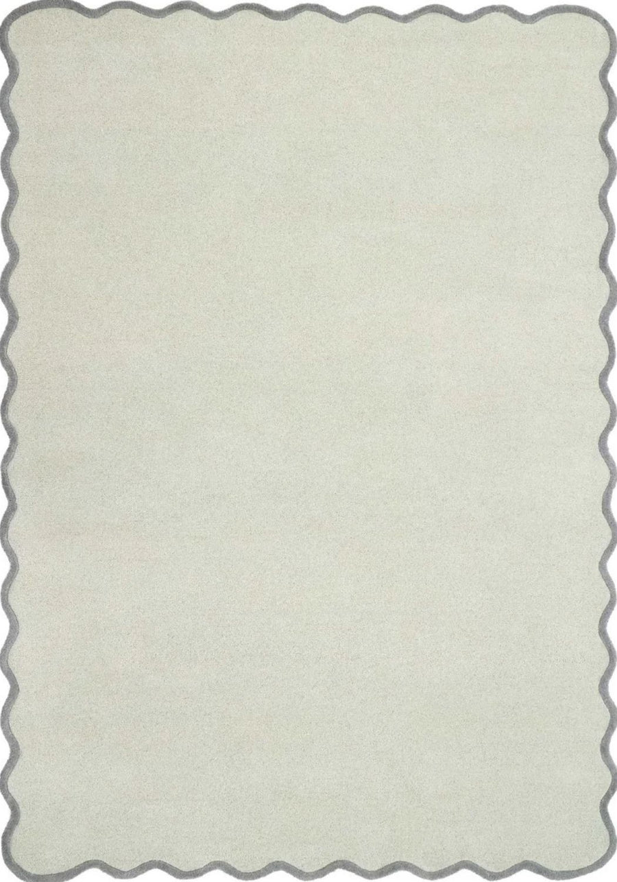 Rectangular area rug with scalloped edge in a light gray color on a white background
