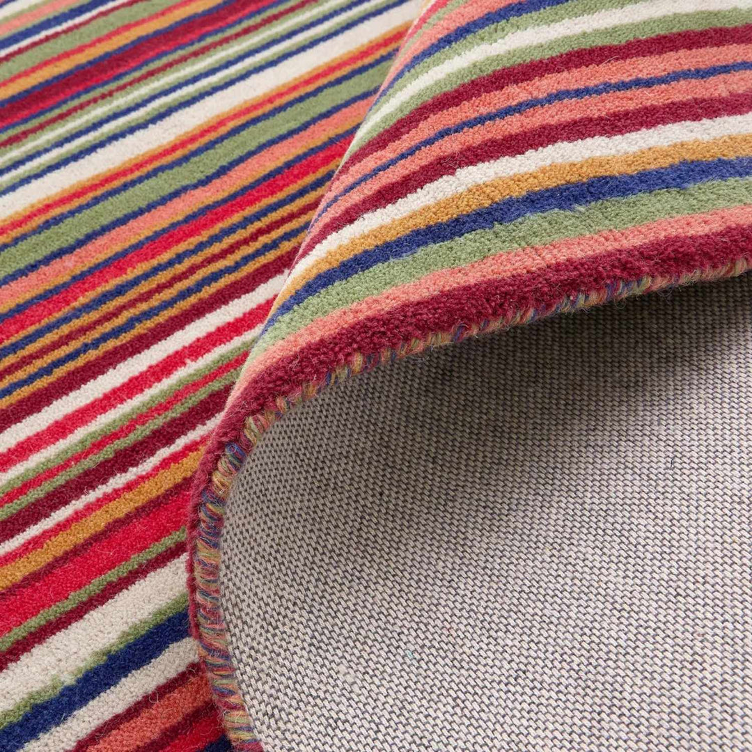 Close-up of a multicolored striped fabric with a textured gray border.