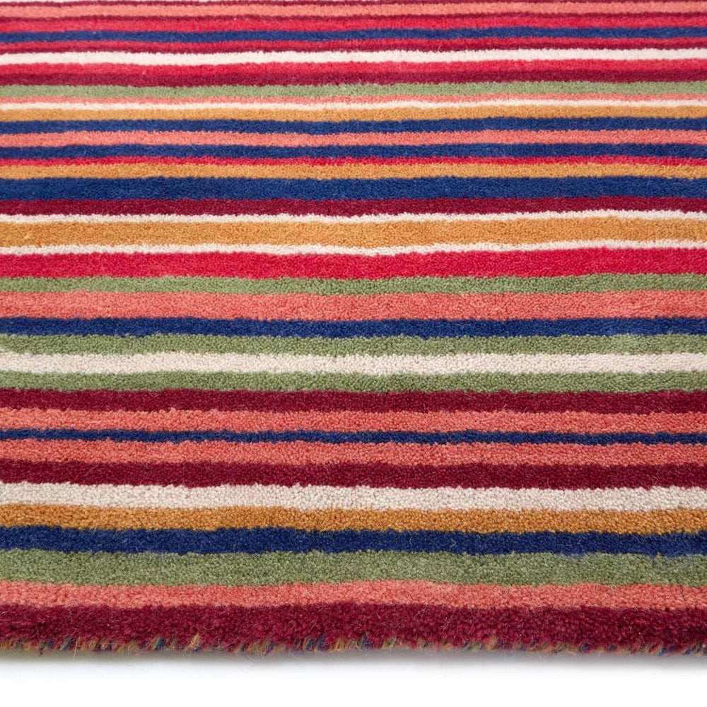Multicolored striped rug with red, blue, green, and orange stripes on a white background
