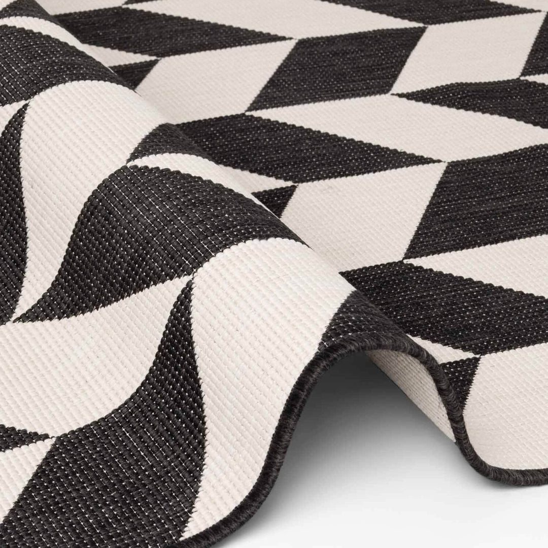Close-up of a black and white geometric patterned rug.