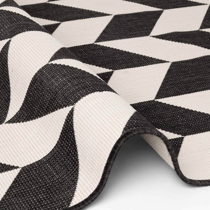 Close-up of a black and white geometric patterned rug.