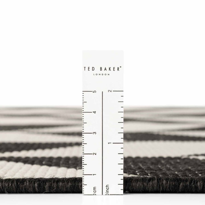 Ted Baker London rug with a ruler for scale on a white background